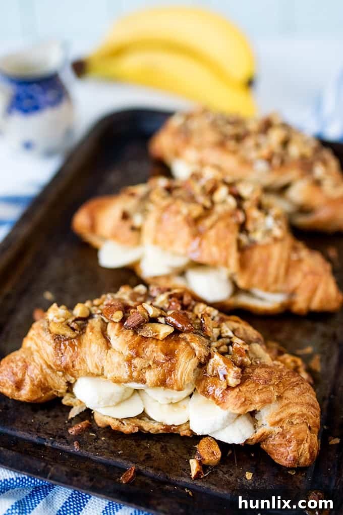 Sticky banana croissants on a baking sheet, fresh from the oven.