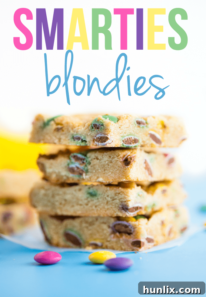 Overhead shot of Smarties Blondies with a decorative text overlay, emphasizing their visual appeal and deliciousness.