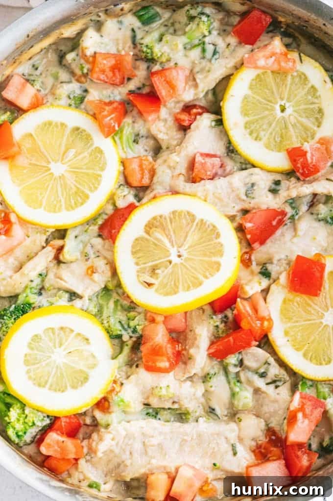 Zesty Lemon Herb Chicken Fettuccine 6 Cooked chicken strips tossed with broccoli in a pan for the fettuccine dish