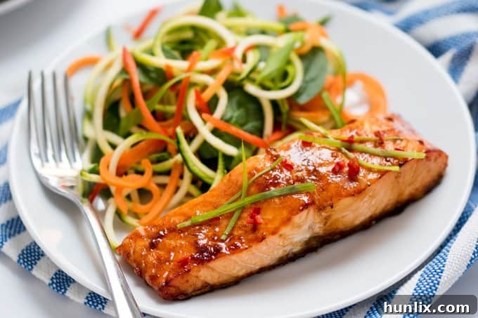 Perfectly baked honey garlic salmon fillets, garnished with fresh herbs, ready for a healthy dinner.