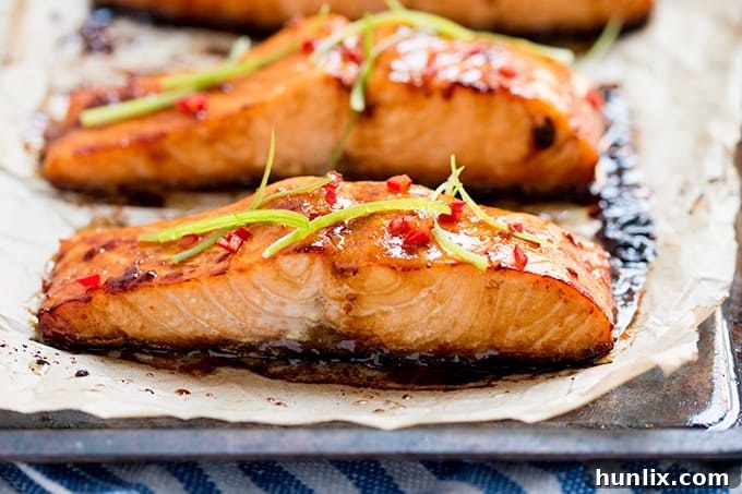 Close-up of a succulent honey garlic glazed salmon fillet, highlighting its tender texture and golden crust.