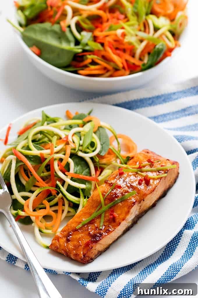 Freshly baked honey garlic salmon, perfectly golden and glazed, resting on parchment paper.