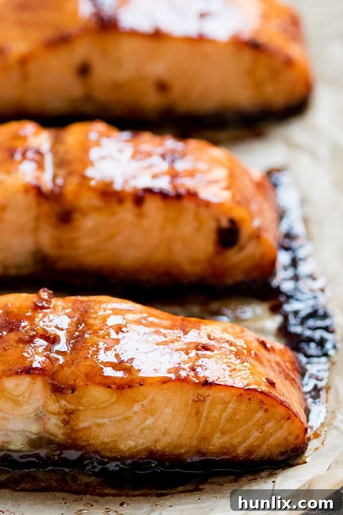 A close-up shot of a beautifully cooked honey garlic salmon fillet, garnished and ready to be enjoyed.