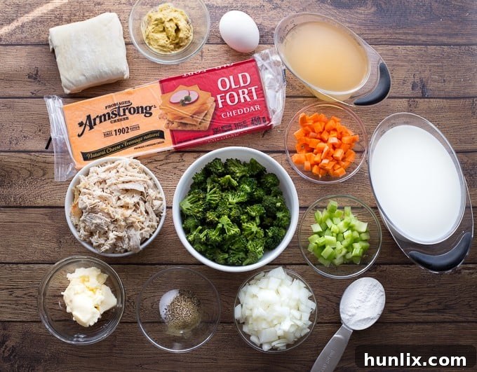Comforting Chicken Broccoli and Cheddar Pot Pies 3 Close-up of a rustic Chicken, Broccoli & Cheddar Pot Pie, showing the golden-brown puff pastry crust with a visible creamy chicken and vegetable filling underneath.