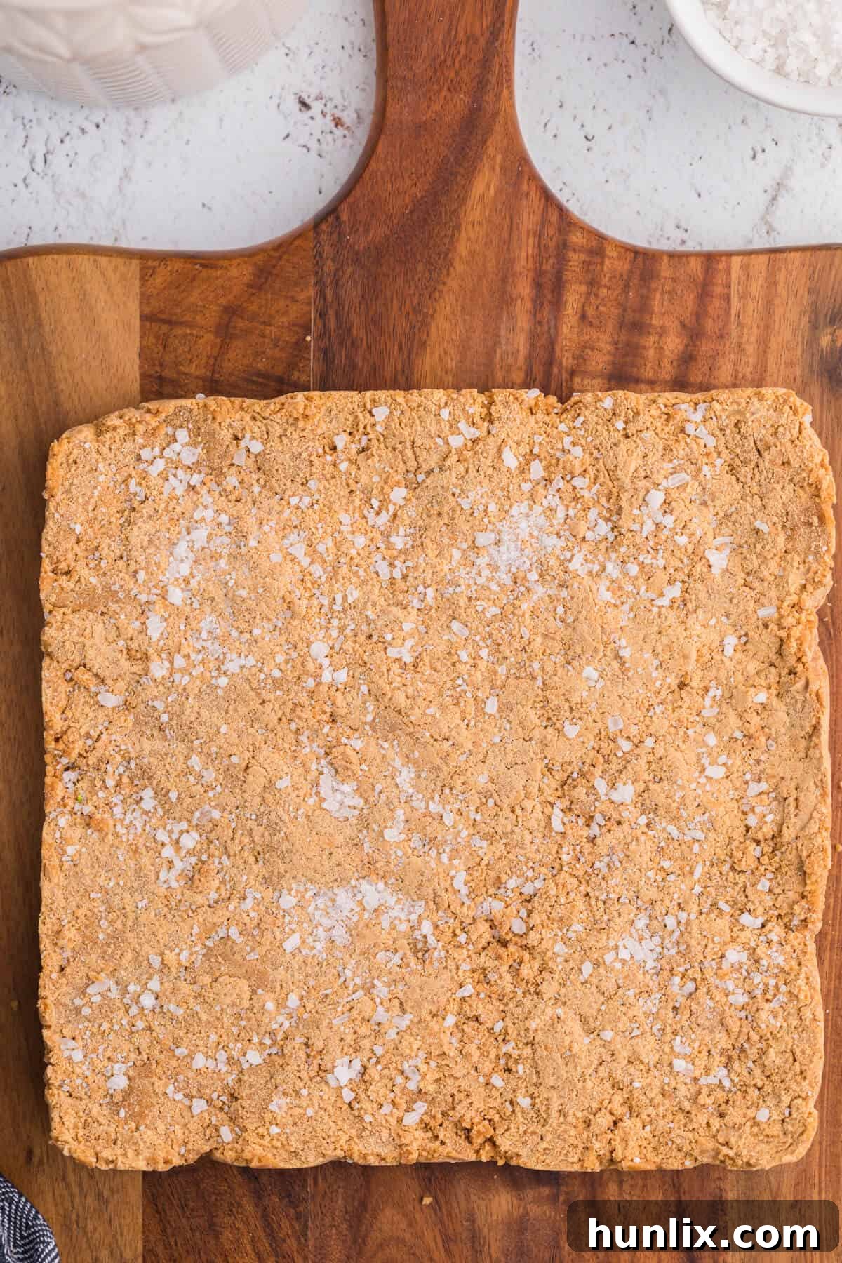 Salted Caramel Delight Fudge 2 Salted caramel fudge on a wooden cutting board.