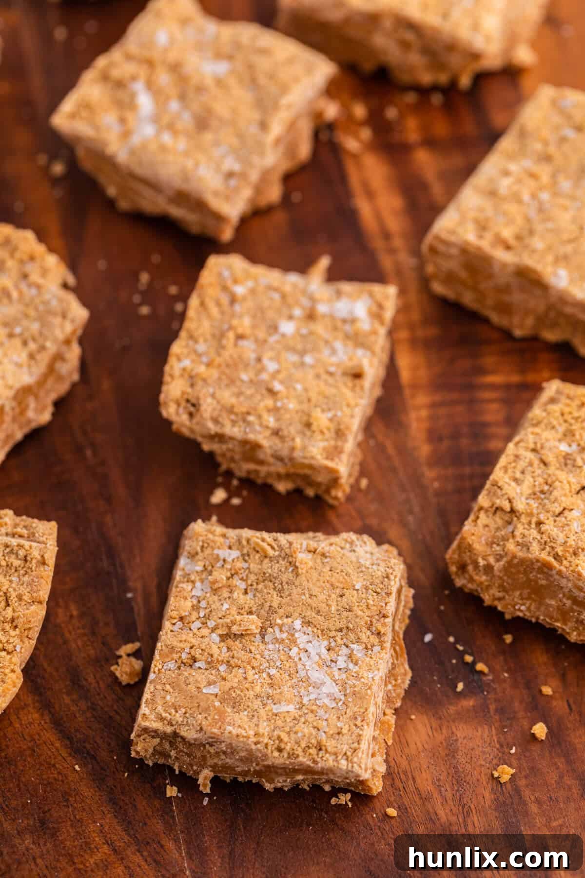 Salted Caramel Delight Fudge 5 Salted caramel fudge cut into squares on a cutting board.