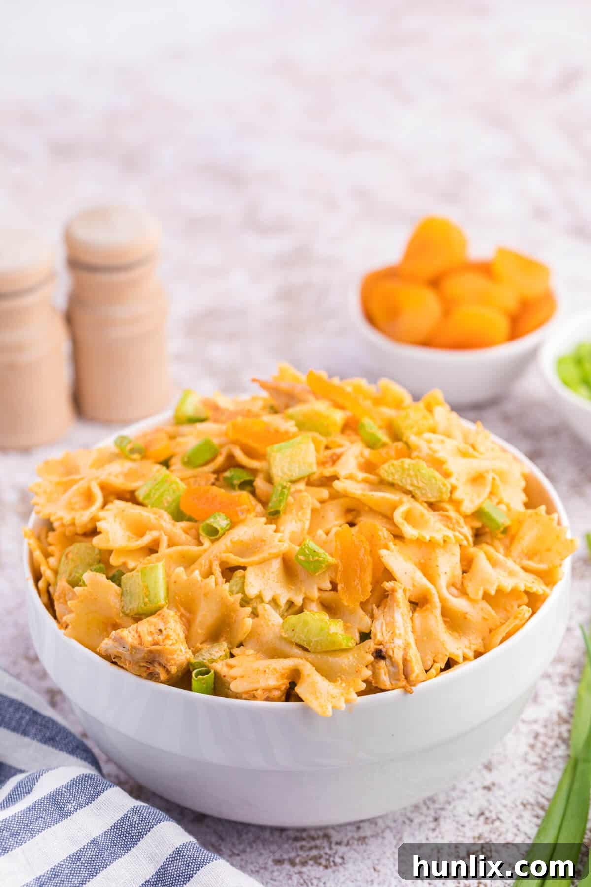 Golden Curry Chicken Pasta Salad 3 A vibrant bowl of creamy curried chicken pasta salad with fresh ingredients.