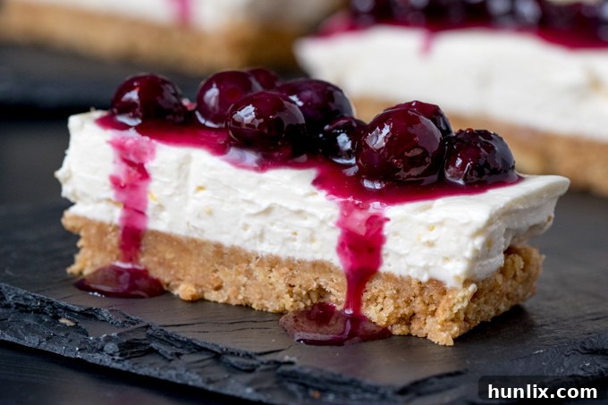 Delicious Blueberry and Lemon Cheesecake Bars on a dark surface, ready to be enjoyed.