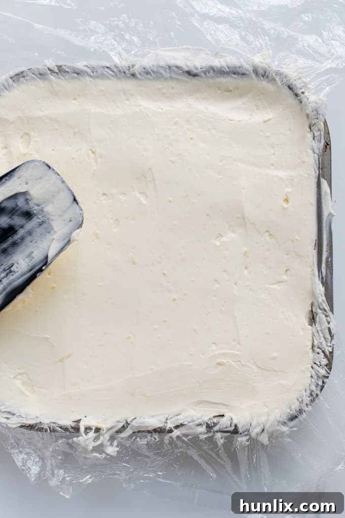 Another view of the cheesecake filling evenly spread in the pan, ready for chilling.