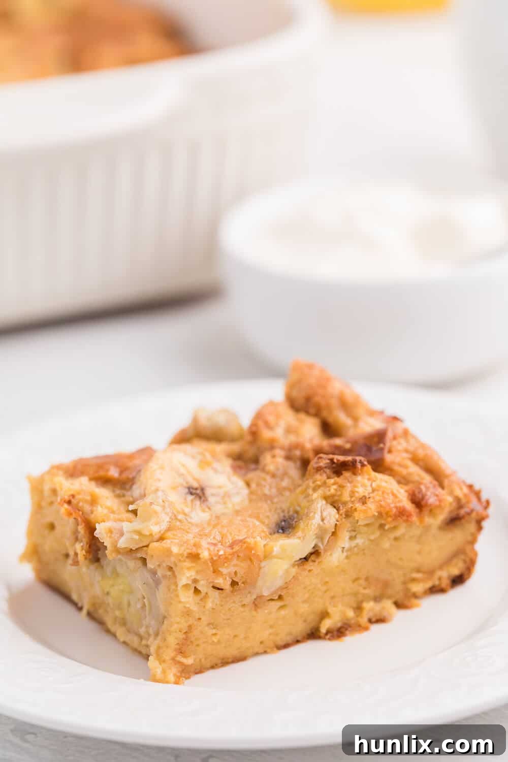 Another appealing shot of a slice of Banana Bread Breakfast Casserole on a plate, highlighting its texture.