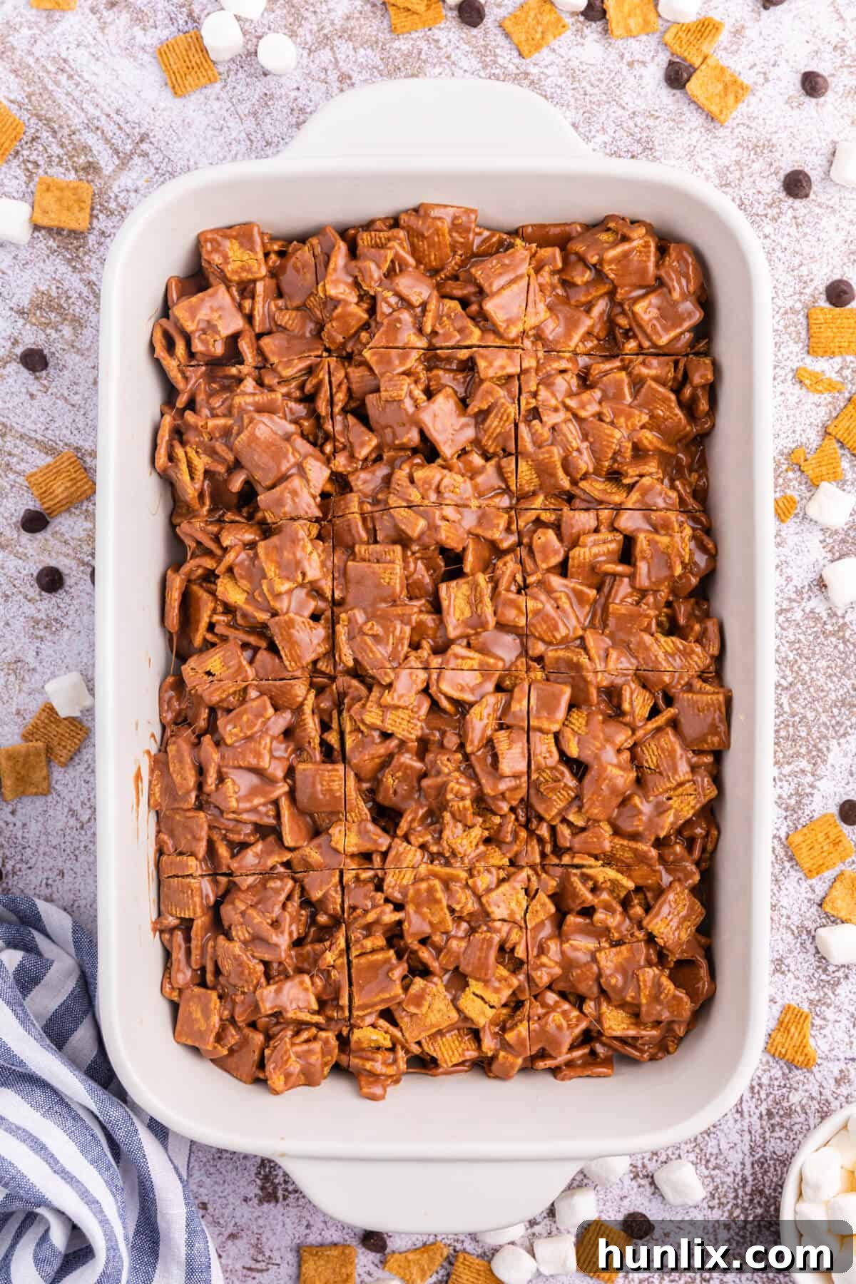 A pan of delicious indoor s'mores, ready to be sliced, showcasing their golden crust and gooey interior.