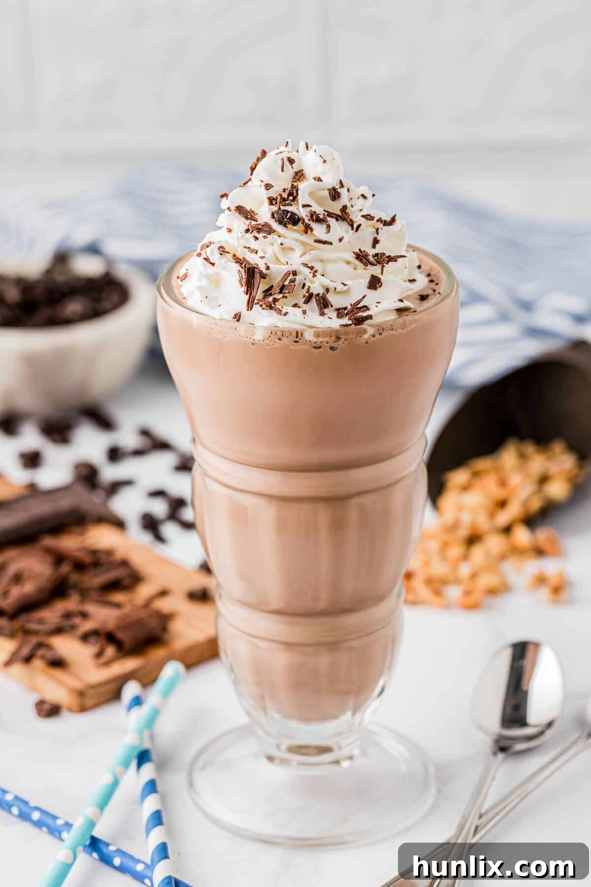 A perfectly blended Nutella coffee milkshake in an elegant glass, topped with whipped cream and chocolate shavings.