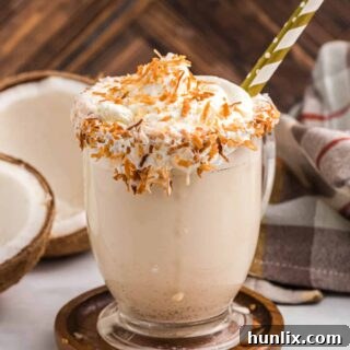 The Coconut Coffee Milkshake recipe on a wooden coaster.