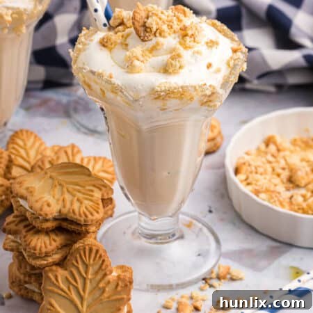 A delicious Maple Coffee Milkshake garnished with whipped cream and cookies.