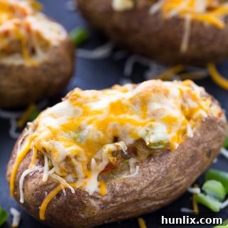 Close-up of a finished Twice Baked Pepper Stuffed Potato, garnished and ready to eat.