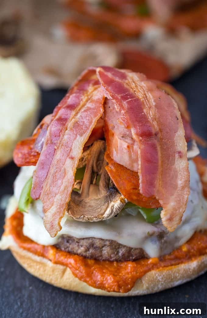 Two strips of grilled, crispy bacon complete the topping ensemble on a Deluxe Pizza Burger.