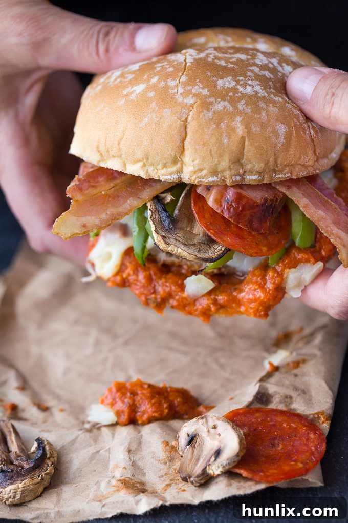 A magnificent Deluxe Pizza Burger, fully assembled and ready to be enjoyed, showcasing all its delicious layers.