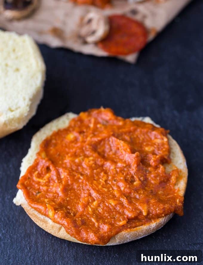 A dollop of Mozza Marinara Dip, the ideal sauce, spread generously on a hamburger bun.