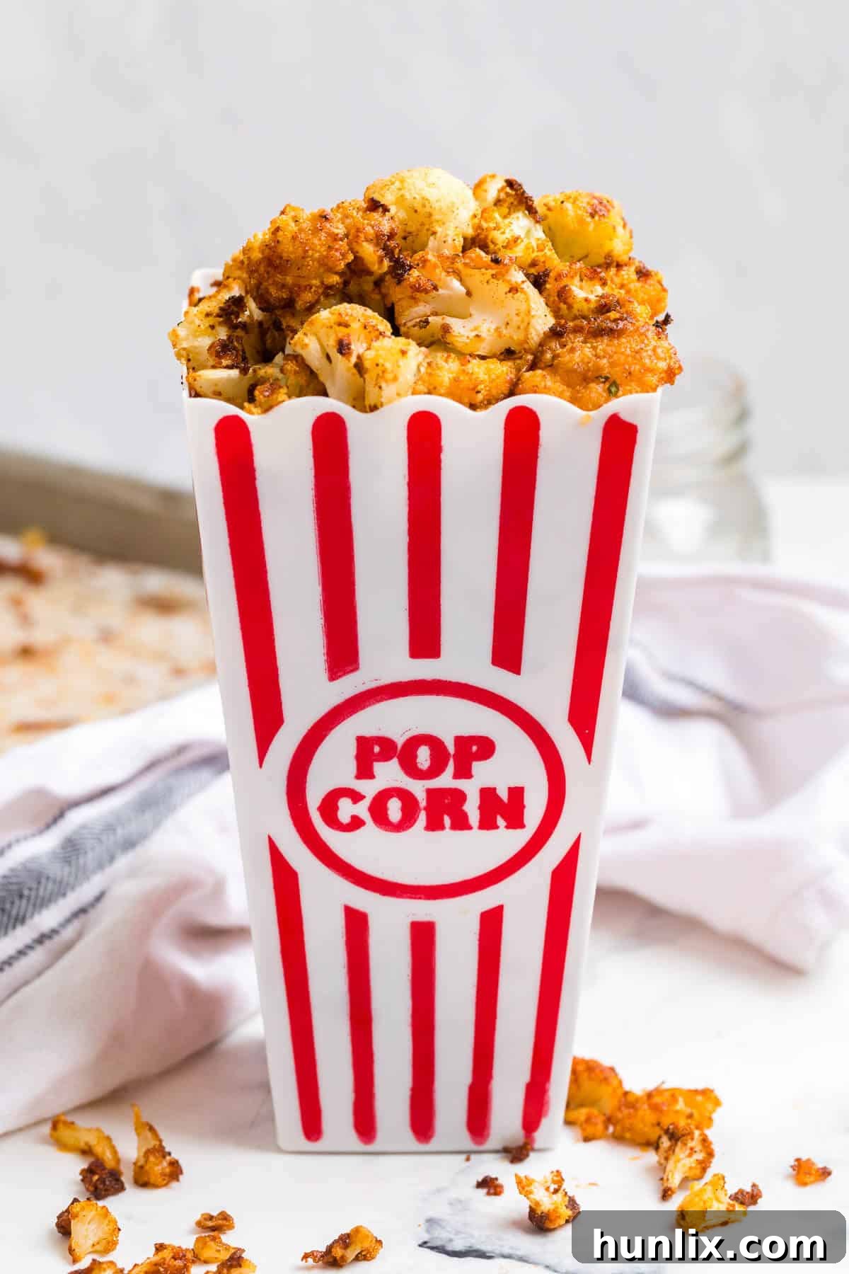 Spicy Buffalo Popcorn 3 Buffalo Cauliflower Popcorn served in a classic popcorn container, highlighting its snack appeal and bite-sized pieces.