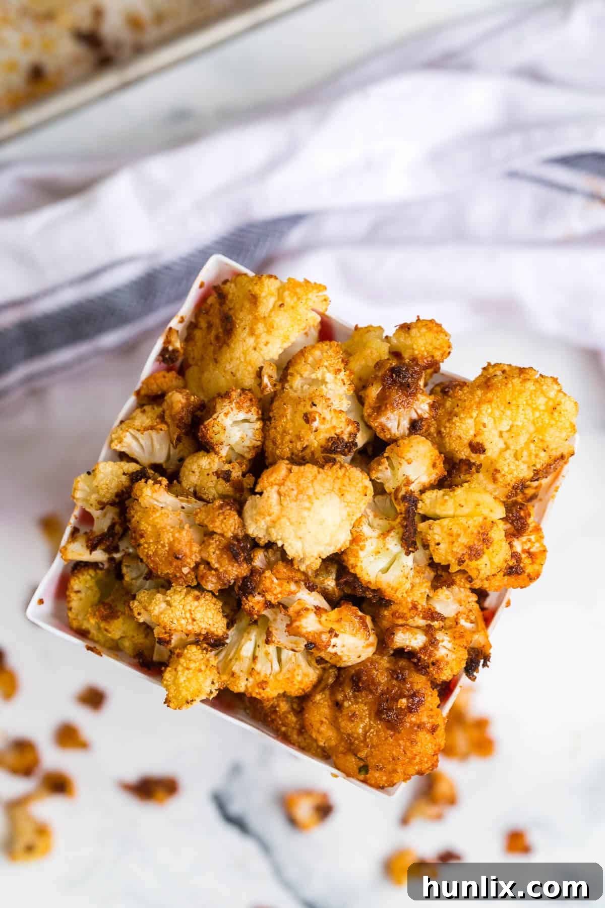 Spicy Buffalo Popcorn 6 Close-up top view of freshly baked Buffalo Cauliflower Popcorn, showcasing its crispy texture and rich seasoning.