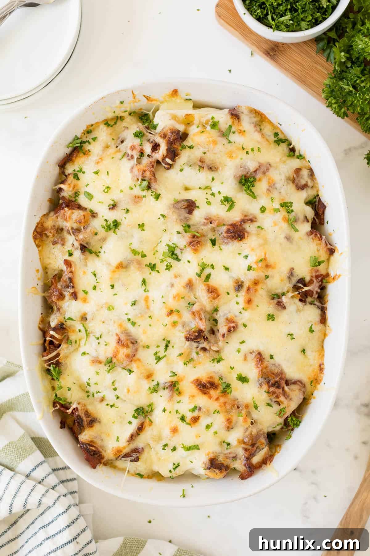 Crispy Bacon Ranch Potatoes 2 A large white casserole dish filled with golden brown Bacon Ranch Potatoes, ready to be served.