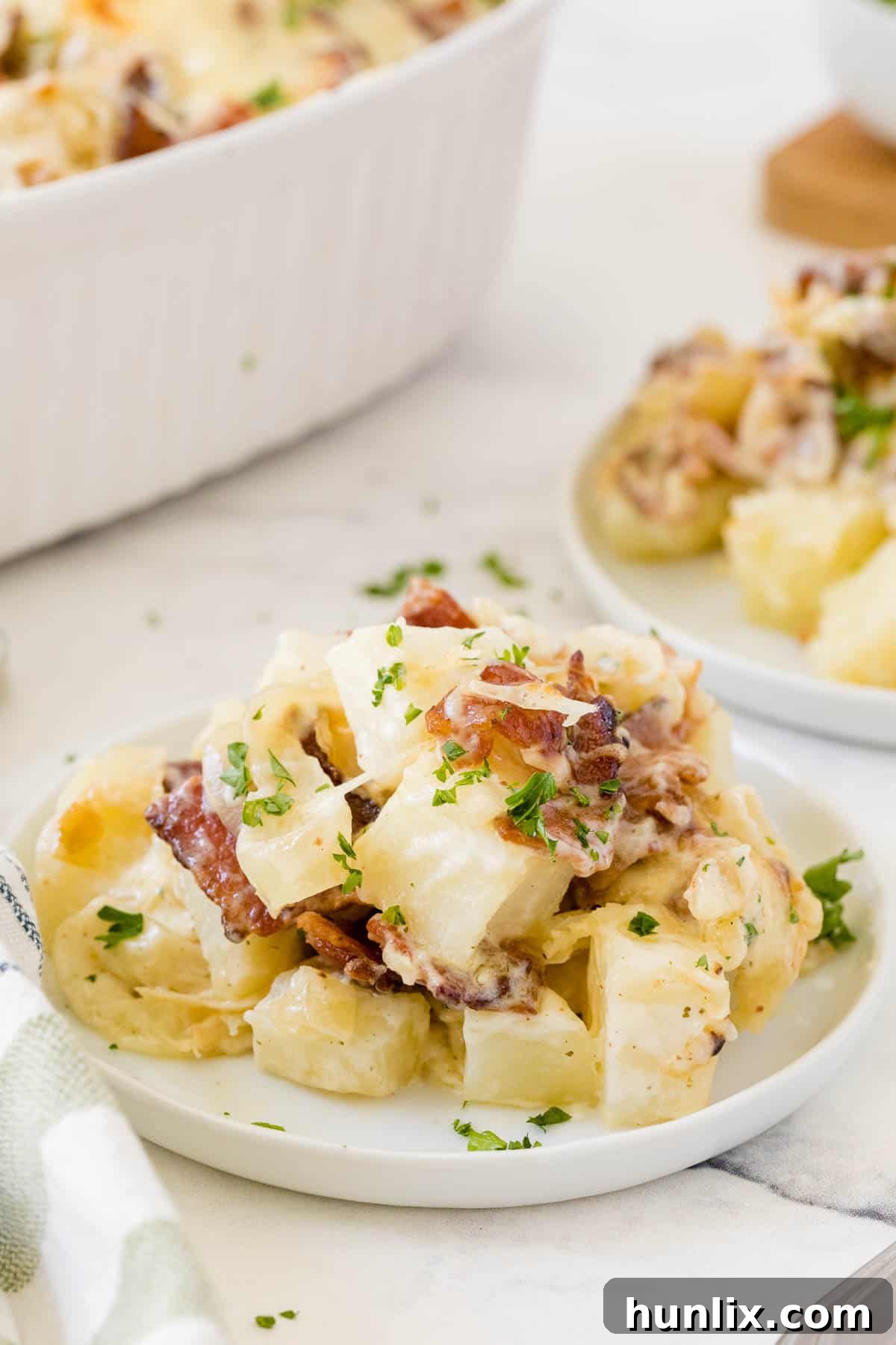 Crispy Bacon Ranch Potatoes 6 A single serving of Bacon Ranch Potatoes presented on a white plate, ready to be eaten.