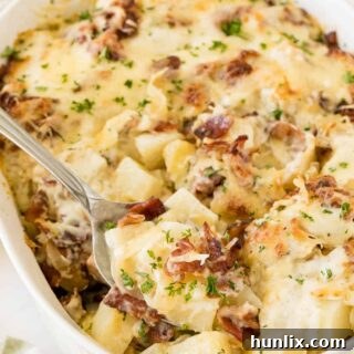 Crispy Bacon Ranch Potatoes 7 Bacon ranch potatoes in a casserole dish with a serving spoon.