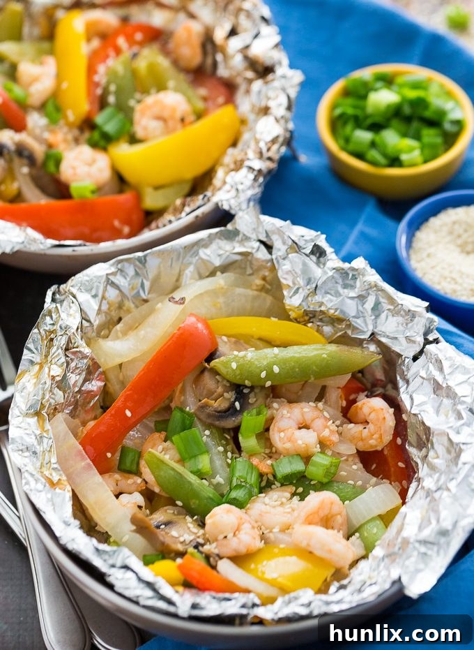 Grilled Sesame Shrimp & Veggies - This summer grilling recipe is a triple whammy - it's easy to prep, simple to cook and fast to clean up afterwards. Your family will love these individual foil packets filled with veggies, shrimp and a mouthwatering sesame sauce.
