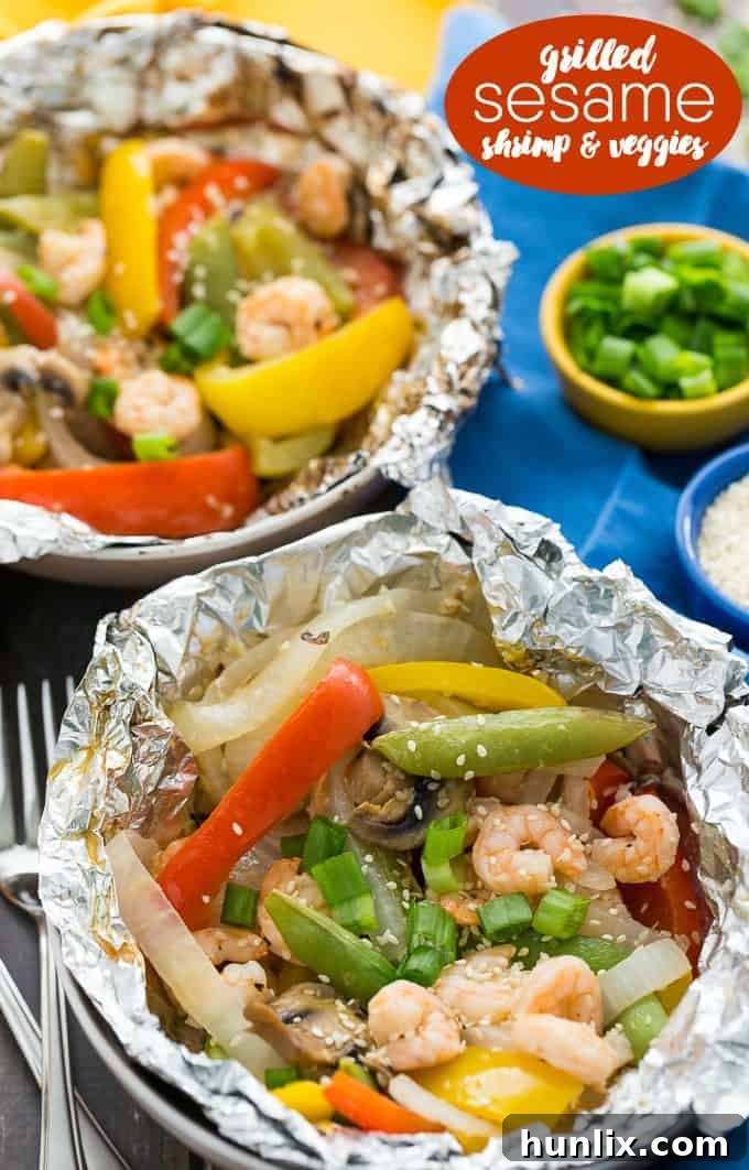 Grilled Sesame Shrimp & Veggies - This summer grilling recipe is a triple whammy - it's easy to prep, simple to cook and fast to clean up afterwards. Your family will love these individual foil packets filled with veggies, shrimp and a mouthwatering sesame sauce.