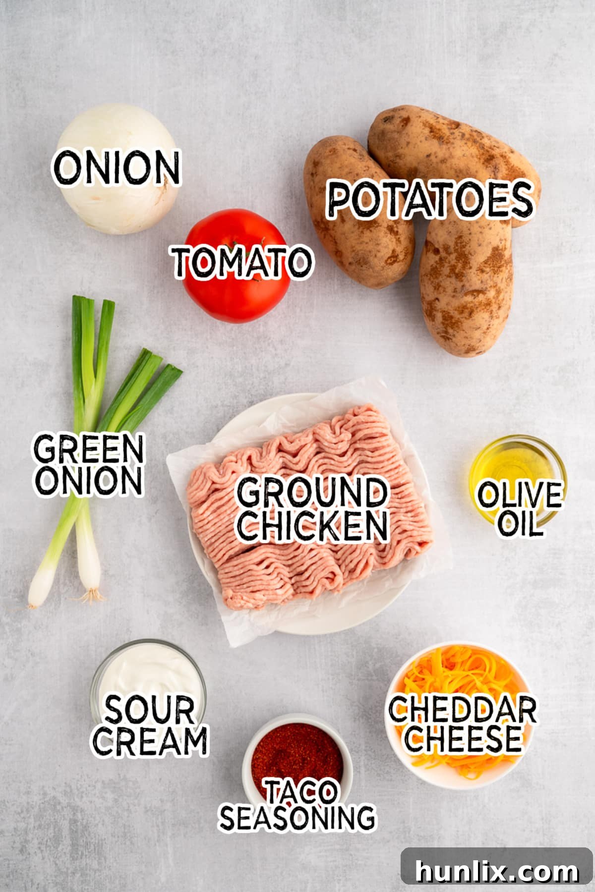 Ingredients for chicken taco twice-baked potatoes laid out on a table.