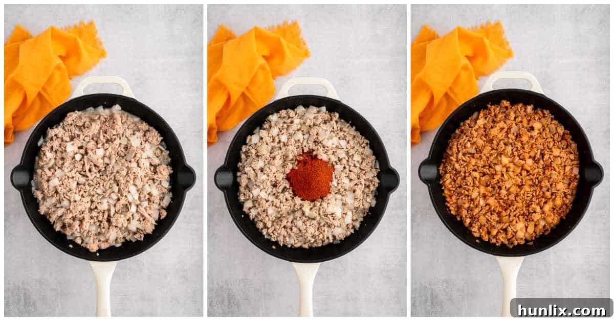 Ground chicken and chopped onions cooking in a skillet, part of the chicken taco twice-baked potatoes preparation.