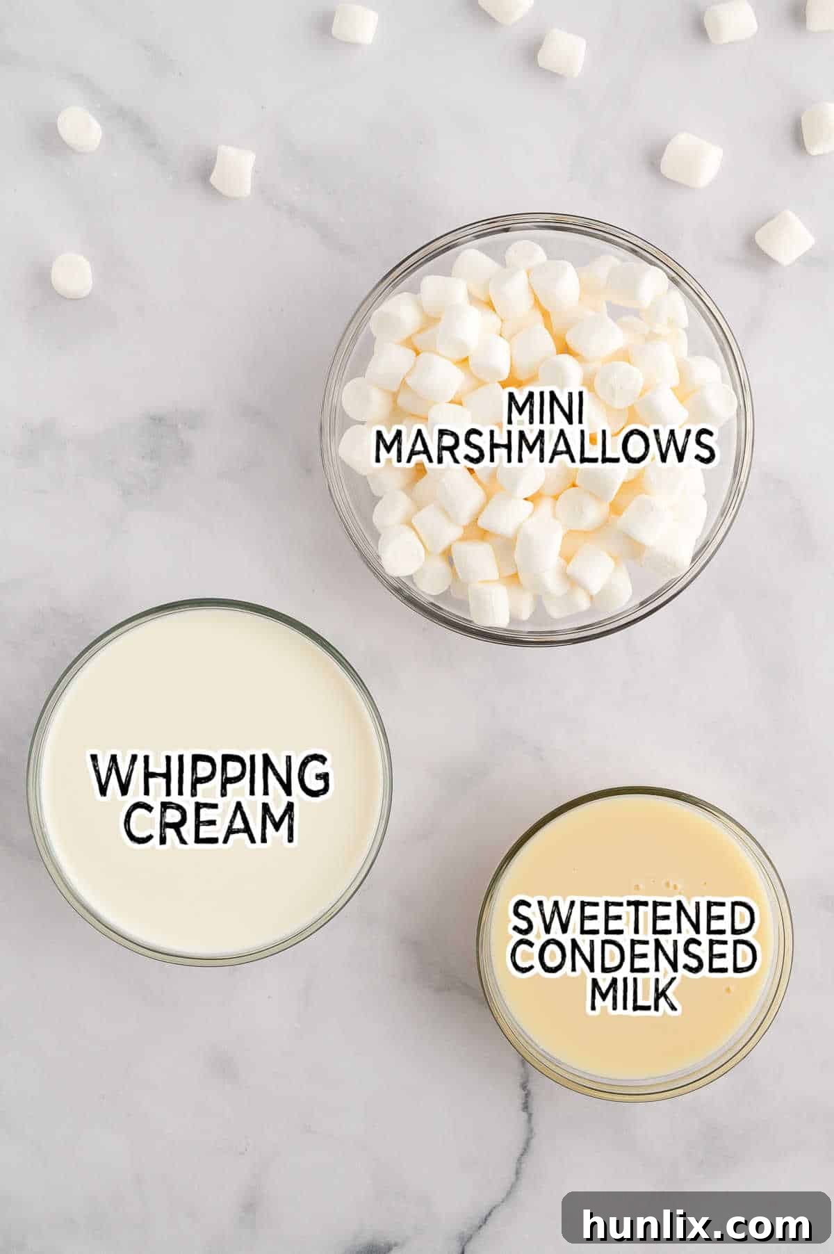 Ingredients laid out on a wooden surface, ready to make toasted marshmallow ice cream.