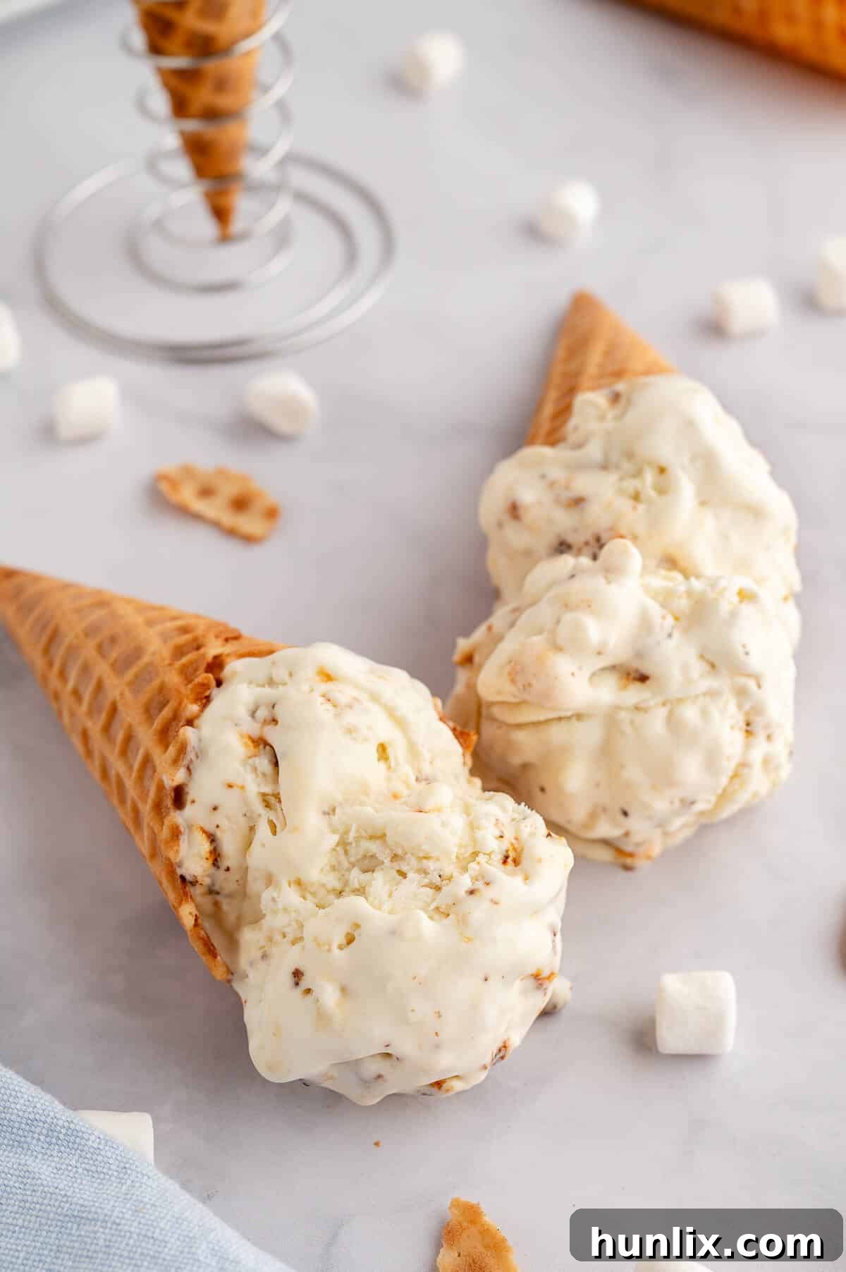 Two ice cream cones generously filled with toasted marshmallow ice cream.