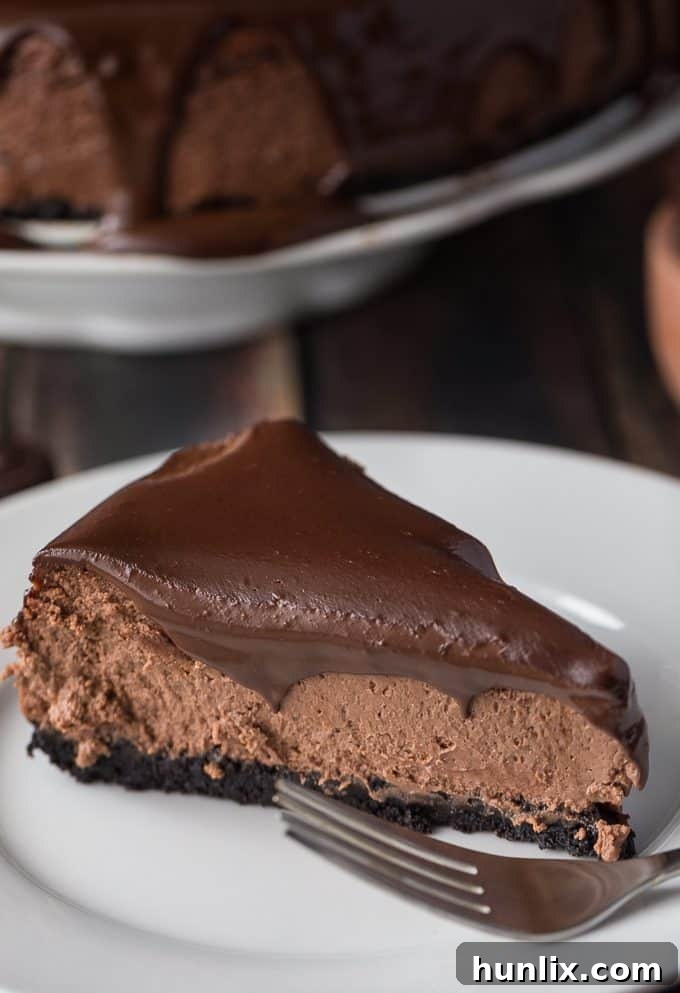 A delightful slice of Saint Lucian Chocolate Cheesecake revealing its creamy layers and rich chocolate ganache, a truly irresistible treat.