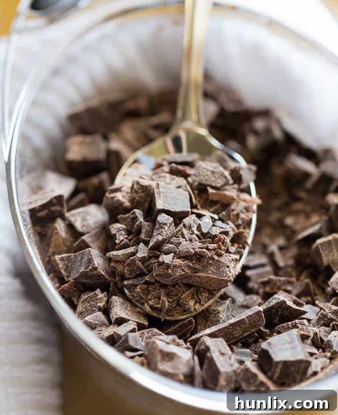 A generous amount of premium Saint Lucian dark chocolate, finely chopped and ready to be melted for a truly decadent cheesecake.