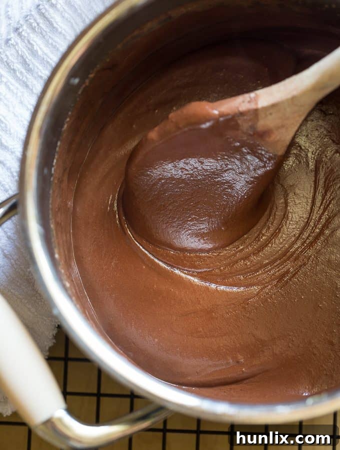 The luxurious, unbaked Saint Lucian chocolate cheesecake batter, a rich, dark, and smooth mixture ready for the springform pan.