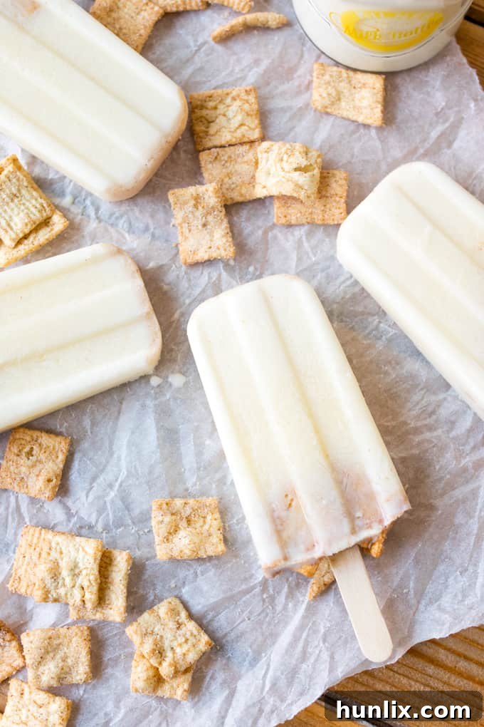 A close-up of cereal milk popsicles arranged on parchment paper, highlighting their delightful simplicity.
