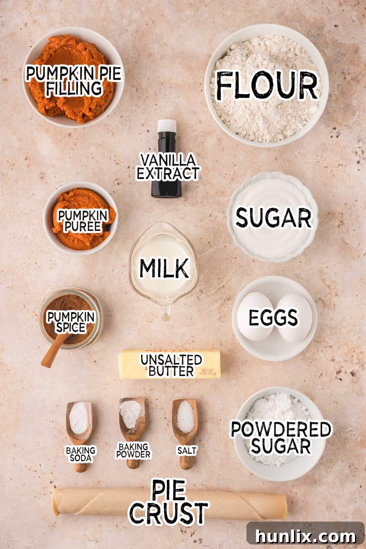 A curated collection of fresh ingredients laid out on a rustic brown surface, including pumpkin puree, spices, flour, butter, and eggs, all ready to be transformed into delicious Pumpkin Pie Cupcakes.