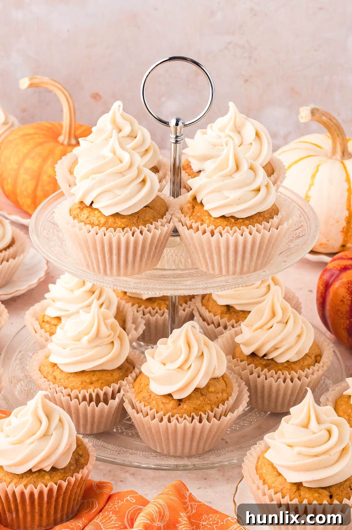 An inviting display of freshly baked Pumpkin Pie Cupcakes, artfully arranged on an elegant cake stand, ready to be enjoyed.