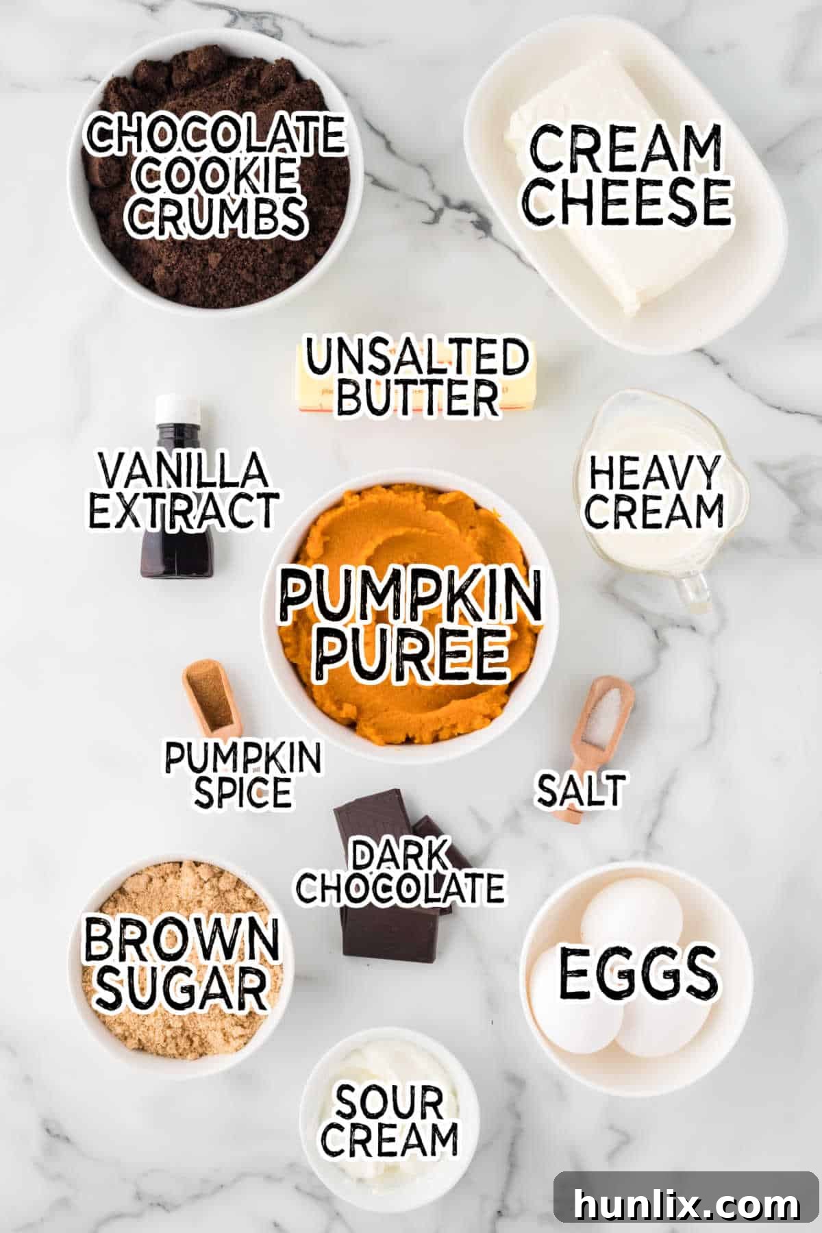 A curated display of all the fresh ingredients needed to bake a delicious chocolate pumpkin cheesecake.