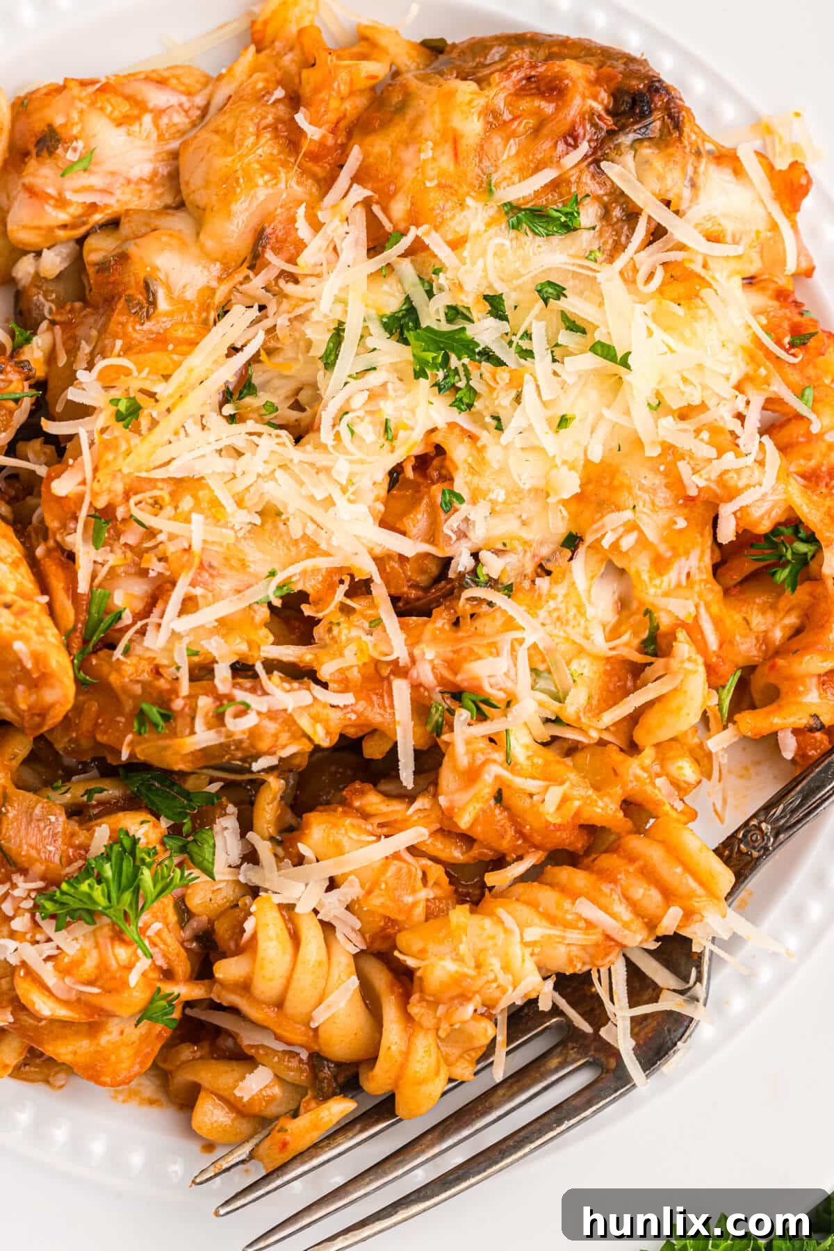 Baked Chicken with Tarragon Pasta 9 A beautifully plated serving of baked chicken and tarragon pasta, garnished with fresh herbs.