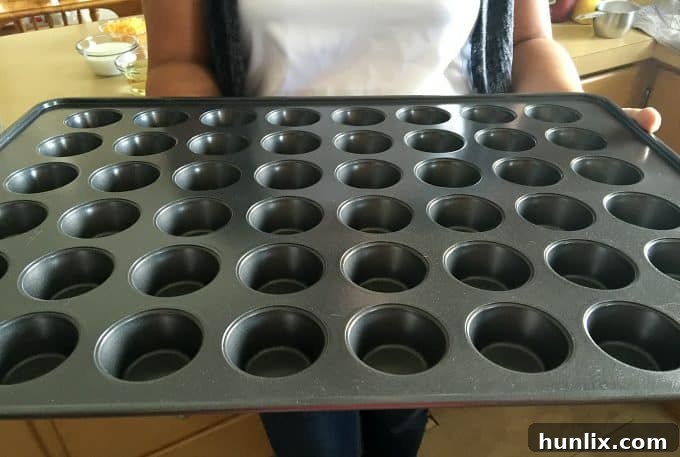 Cheeseburger Bites 2 Delicious mini cheeseburger muffins, perfect for game day appetizers and parties, arranged in a muffin pan.