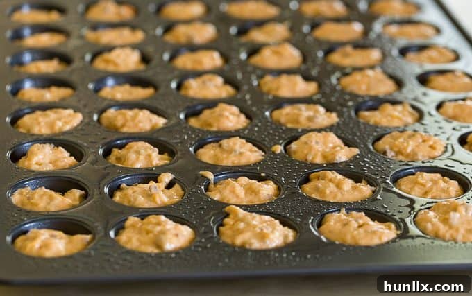 Cheeseburger Bites 4 A large batch of freshly baked mini cheeseburger muffins cooling in the pan, waiting to be filled.
