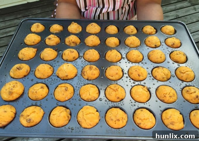 Cheeseburger Bites 5 Hollowing out the center of mini muffins with an apple corer to prepare for the cheeseburger filling.