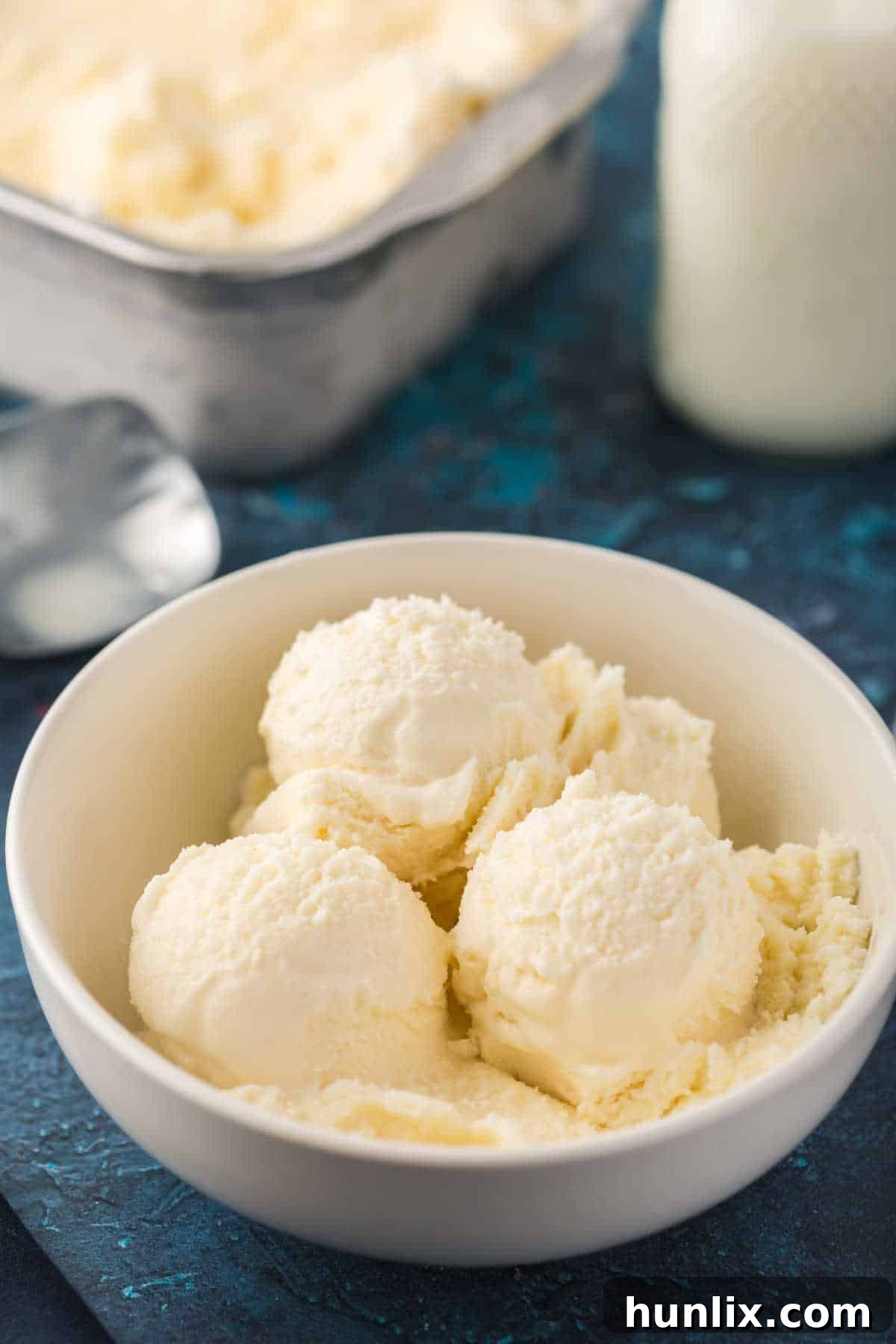 Homemade vanilla ice cream served in a clear bowl, showcasing its smooth texture.