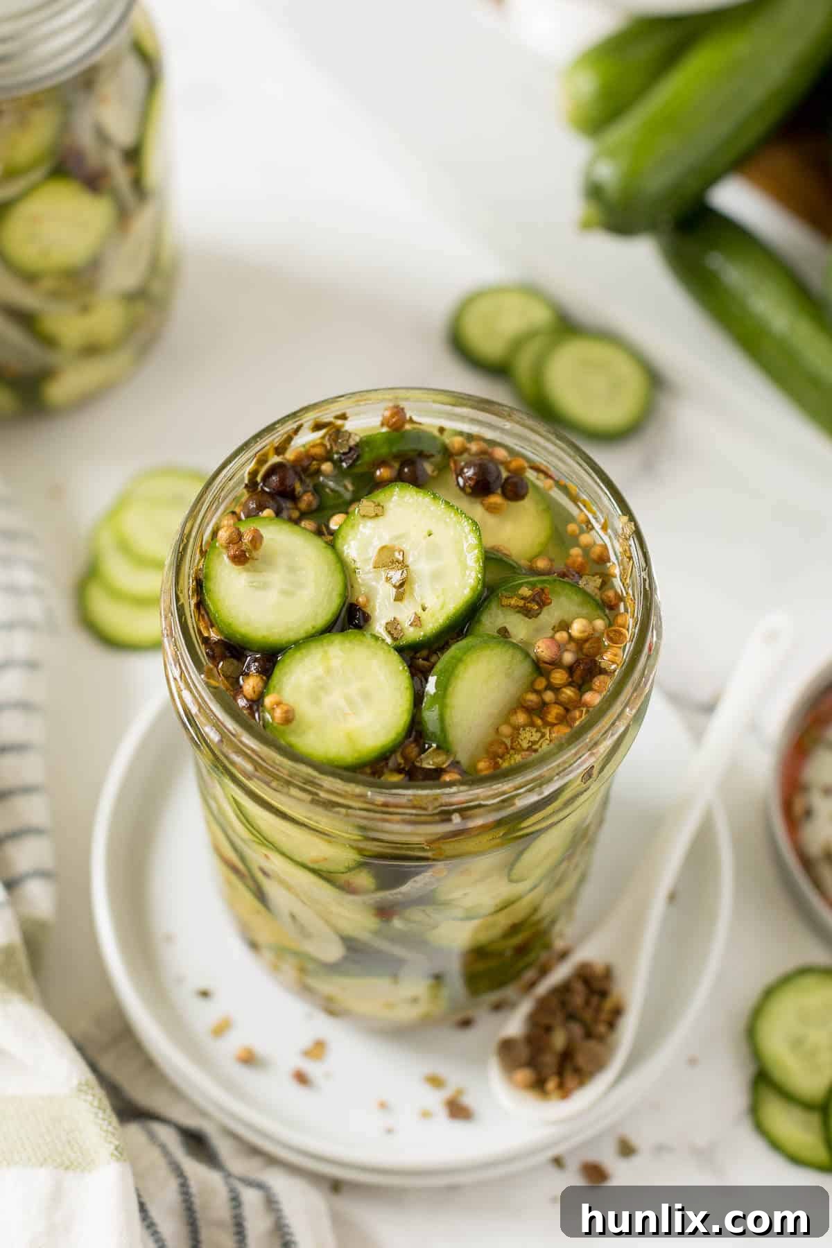 A beautifully arranged jar of homemade refrigerator pickles, showcasing their vibrant color and crisp texture. Perfect for easy, quick pickling.