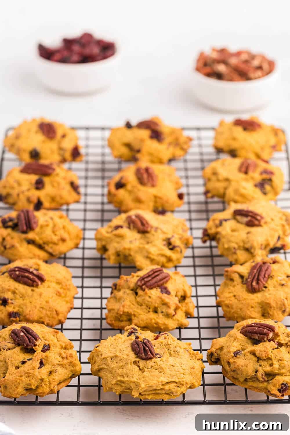Close-up of baked pumpkin breakfast cookies on a wire baking rack, highlighting their golden-brown edges and soft texture.
