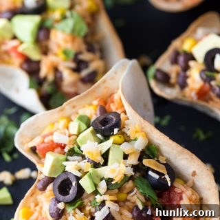 Black Bean & Rice Open-Faced Tacos - The easiest vegetarian taco recipe! These tortilla bowls are stuffed with Mexican rice and can be topped with all your favorites.