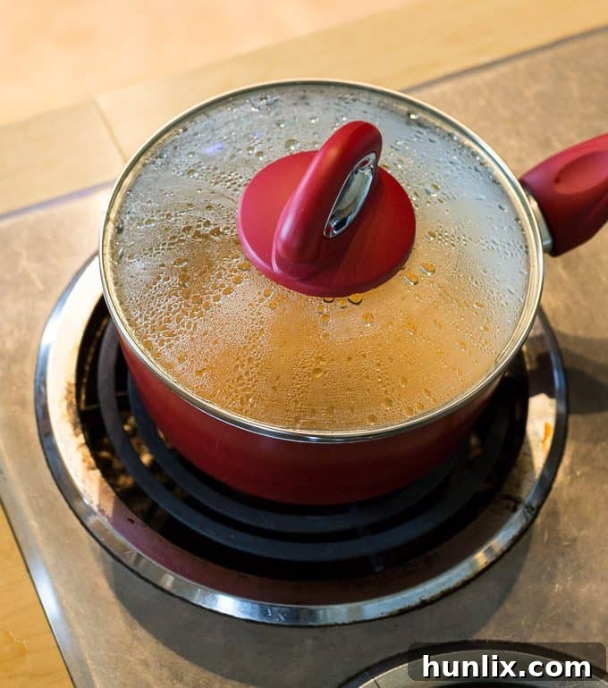 Bridget joyfully pours all the prepared ingredients into a large mixing bowl for the taco filling.