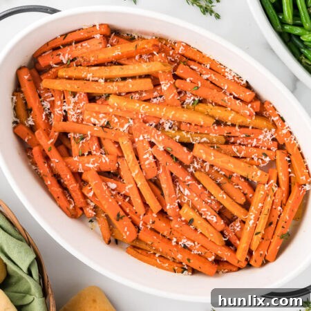 Parmesan roasted carrots in a white casserole dish.